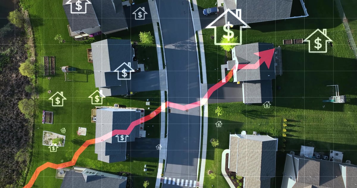 Aerial view of a rural American neighborhood with animated rising arrow and dollar signs symbolizing increasing real estate prices